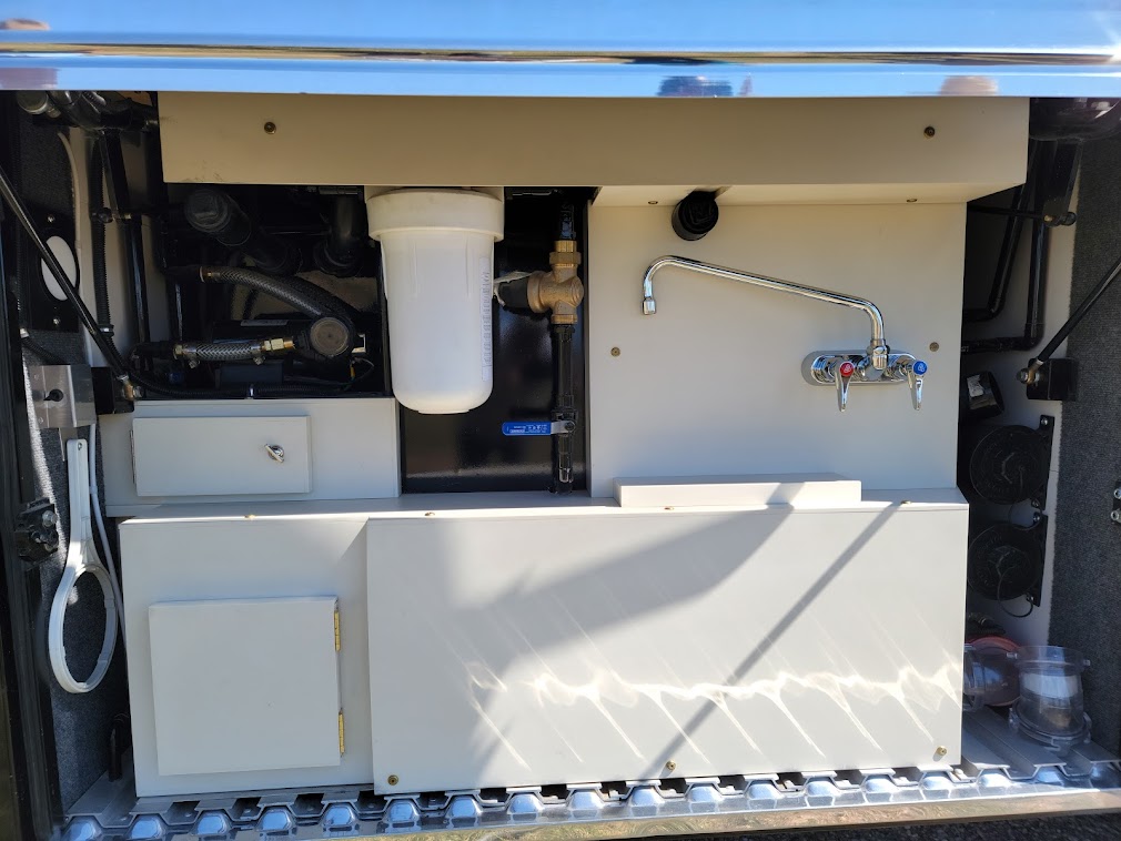 Outside Water faucets are on both sides of the coach.