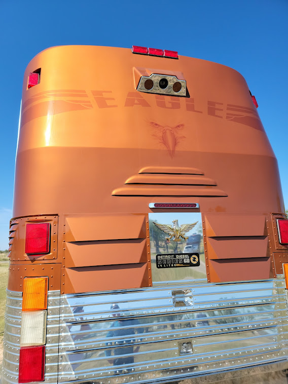 The rear of the bus with a backup camera and lights.
