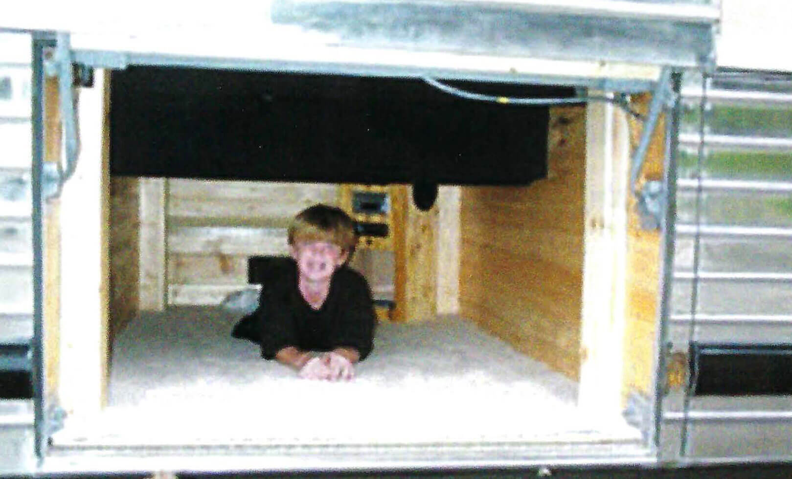 An Underbay Sleeping Compartment in a Bus Conversion - bus conversion photo