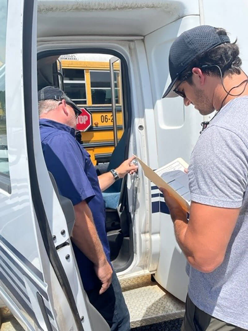 Reviewing the paperwork for the bus sale.