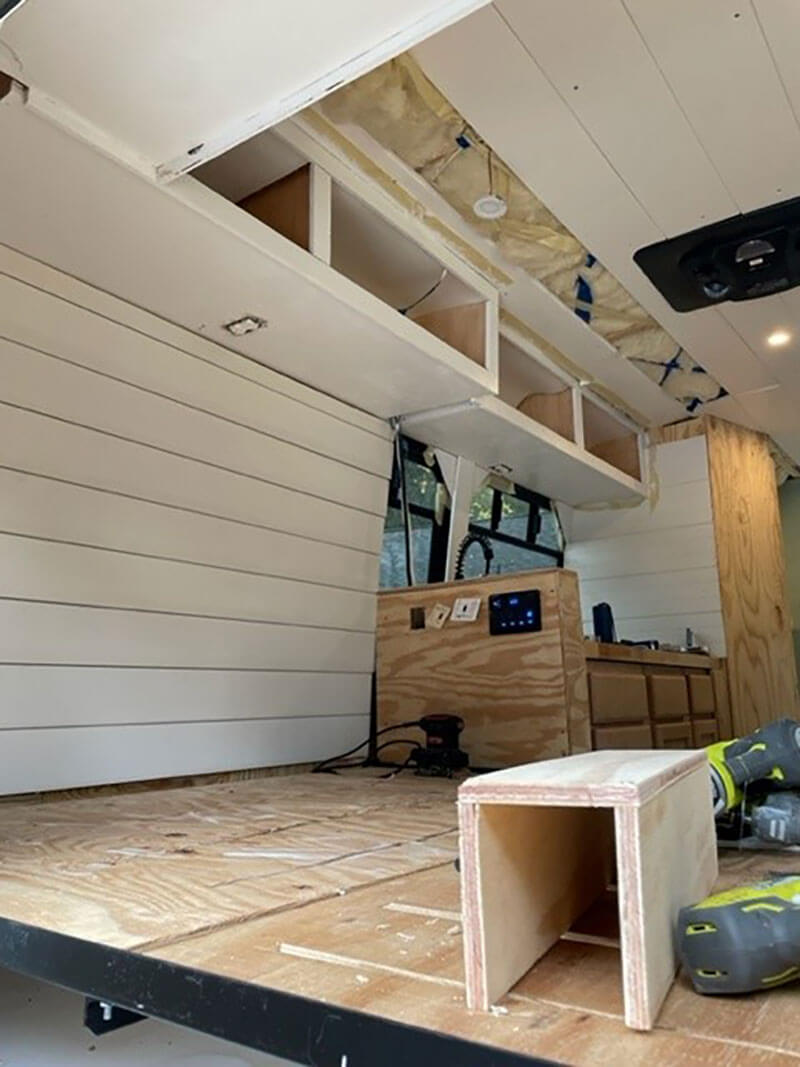 We built cabinets above our bed. We each have two for our clothes.
