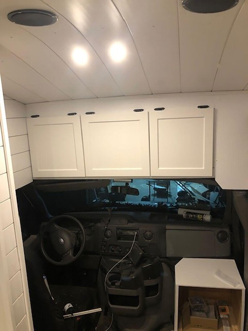 We utilized the empty space above the driver’s seat for three cabinets for storage. We placed knobs and struts on each cabinet.