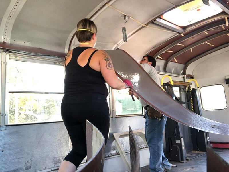 Tony and Annette demo the ceiling of the bus (October 2019).