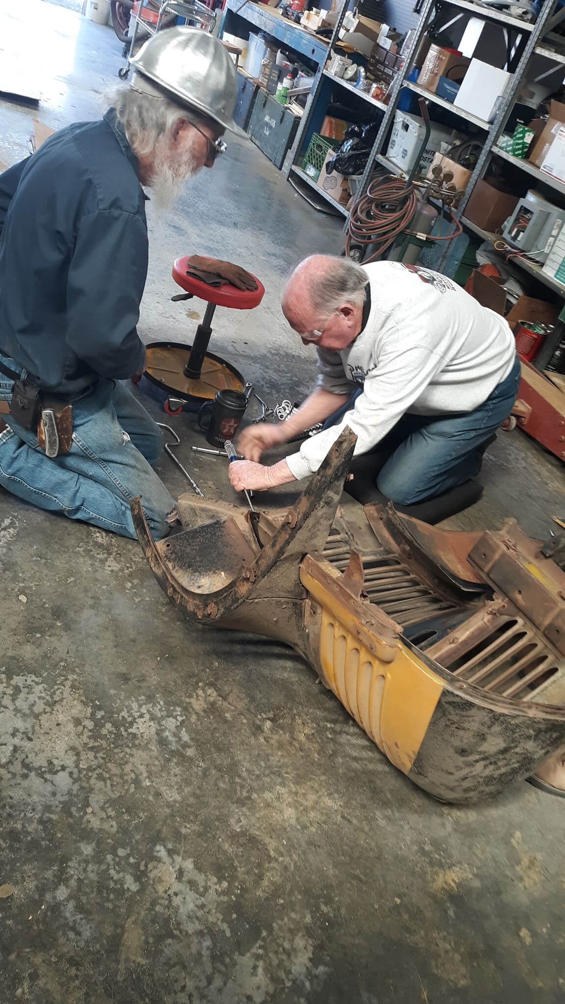 Pat Mackin and Charles Rolofson working on the front grille assembly.