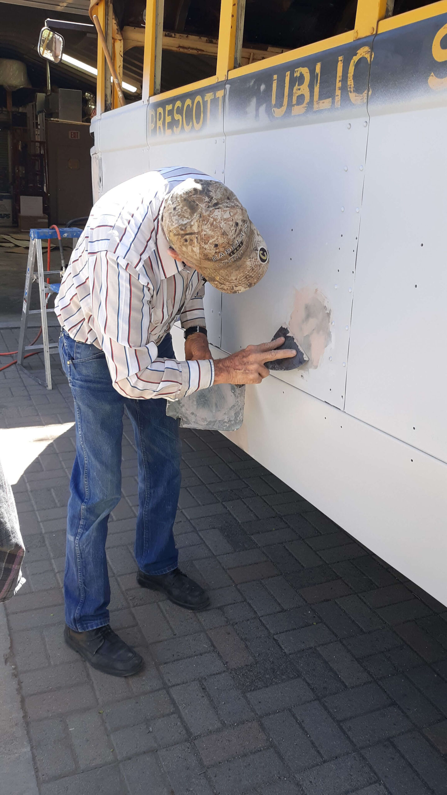Bondo Bob Hinshaw doing what he does best, applying filler for body preparation.