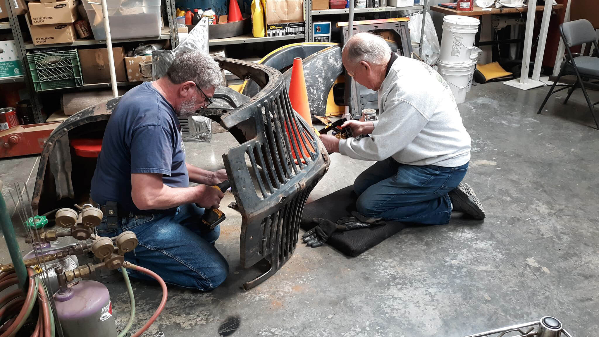 Charles Rolofson and Graig Varga working on the front grille assembly.