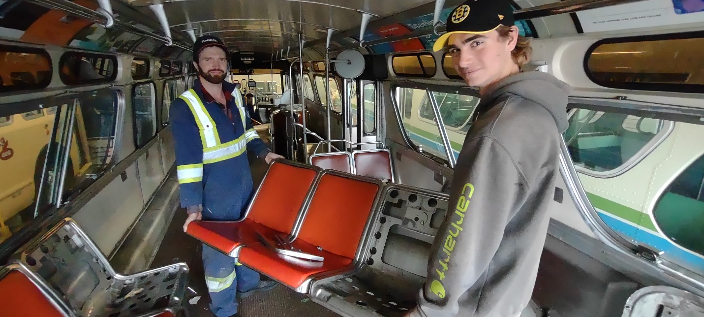 Kyle Little and Milan Streit removing seats.