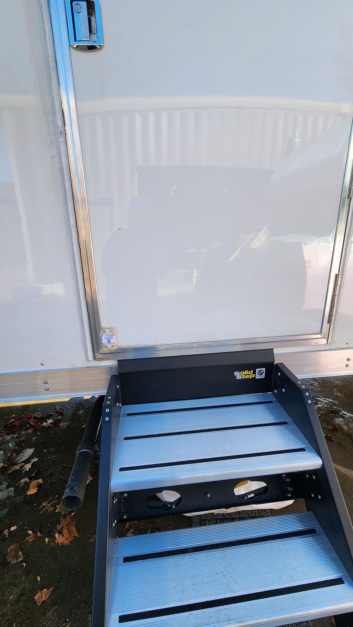The Lippert Solid Steps installed. 