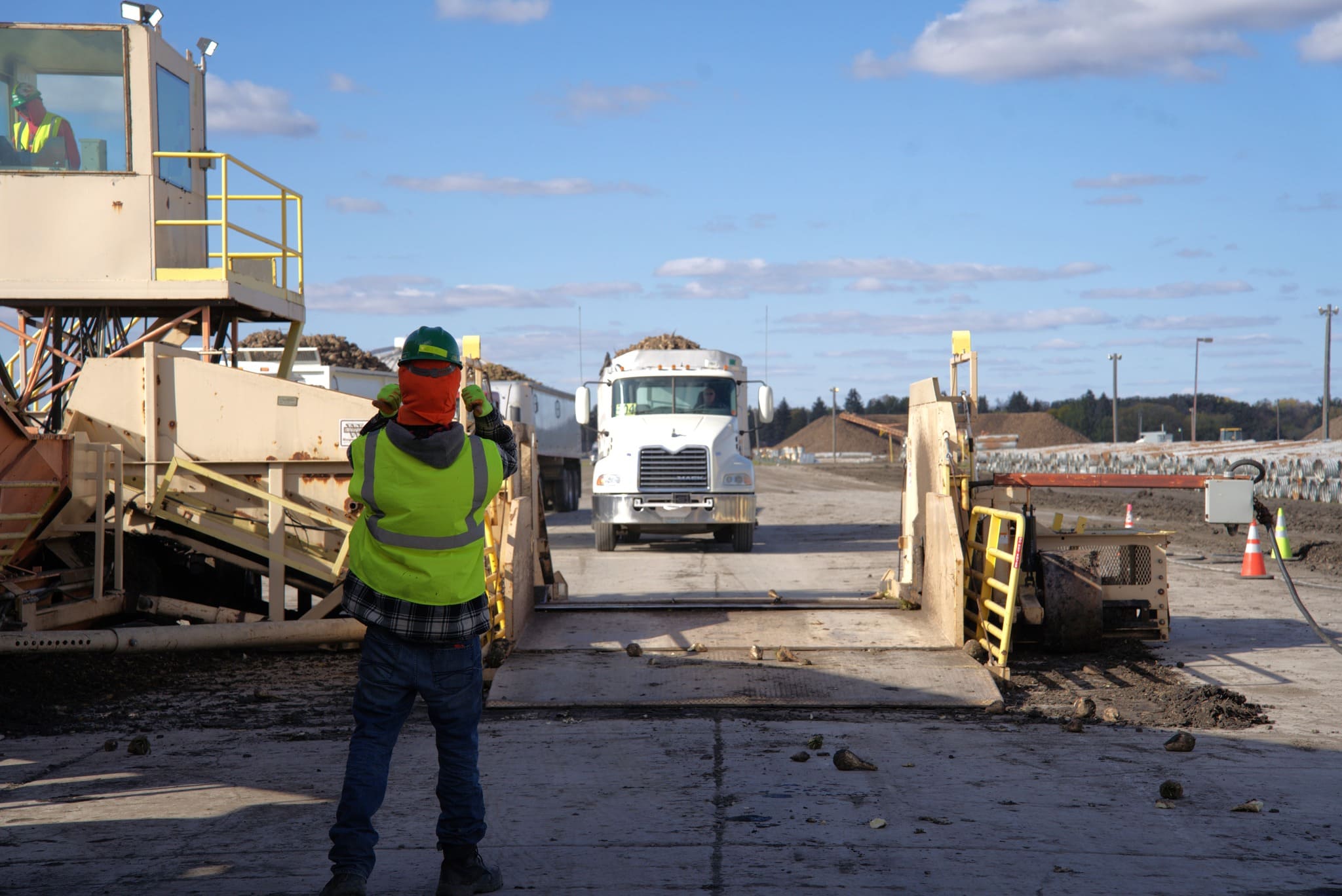 Guiding trucks onto the scales.