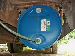 Water tank slung underside of bus, with no protection from rocks and debris.