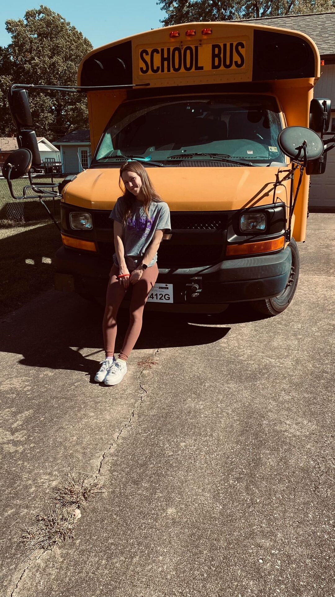 Courtney posing in front of our new bus.